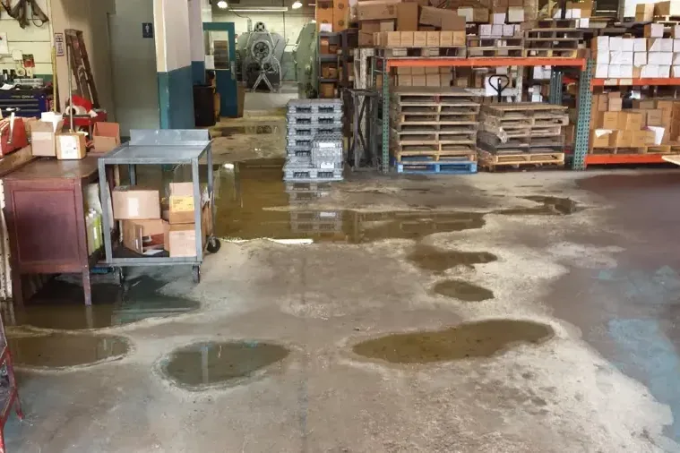 Standing water covering a warehouse floor and adjacent storage space